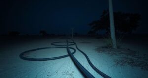 Quiet night scene of Niger landscape with electric cables in the foreground, expressed in realistic colors