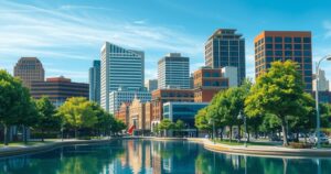 A serene cityscape of Decatur, Alabama, showcasing city buildings under a bright blue sky with trees lining the streets.